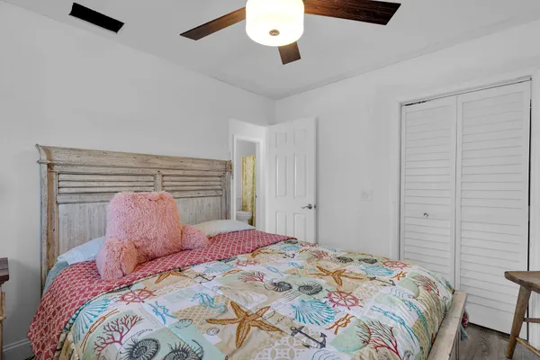 a bedroom with a large bed and a chandelier