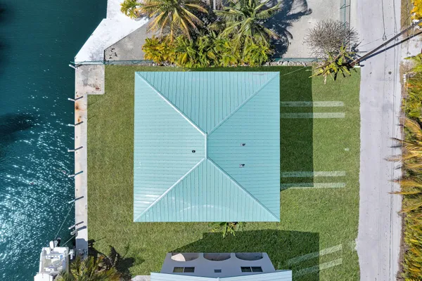an aerial view of a house with a yard