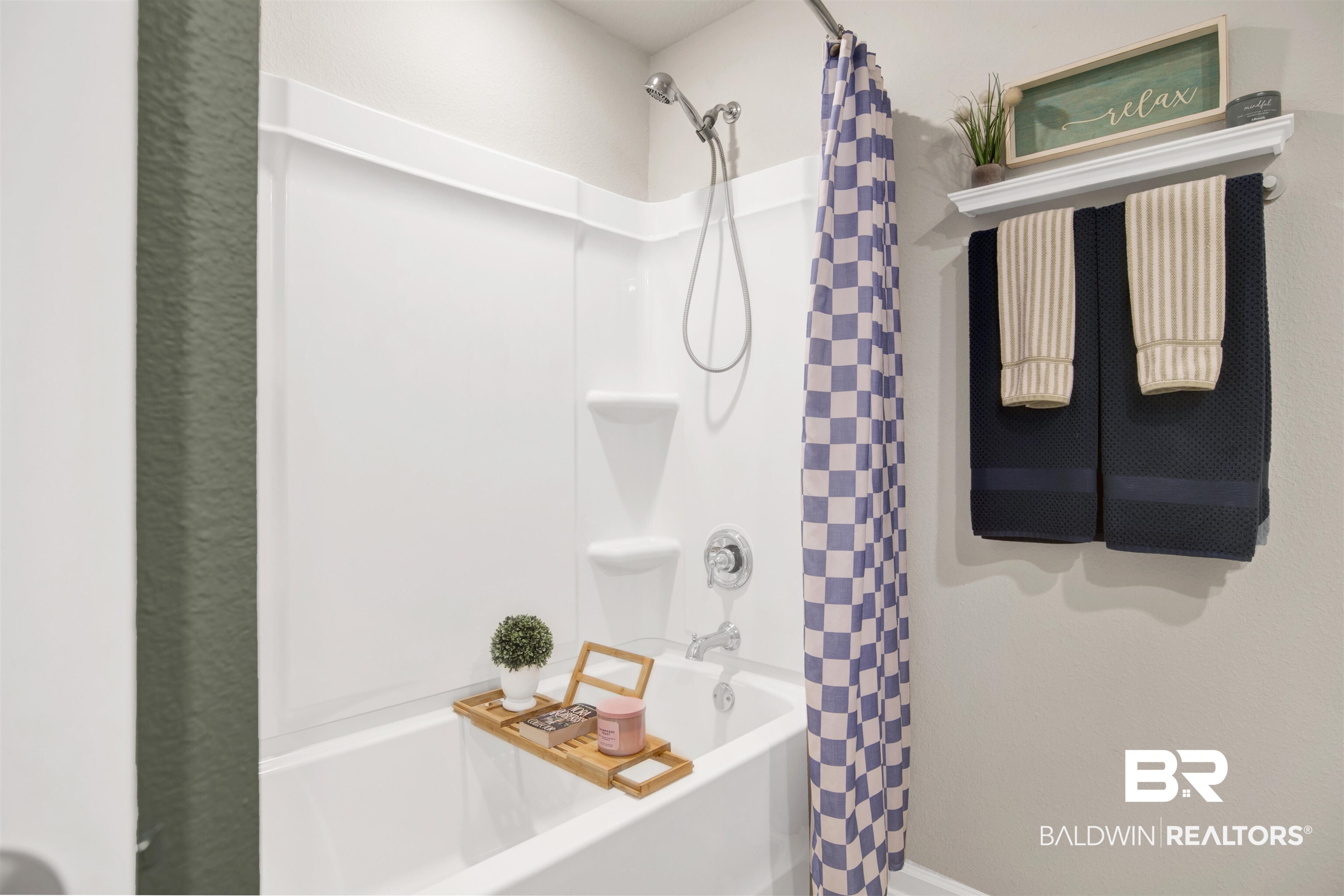 22301 Early Dawn Circle Foley, AL 36535 - Photo 12 of 45 White bathtub with a chrome showerhead and faucet, surrounded by white wall panels