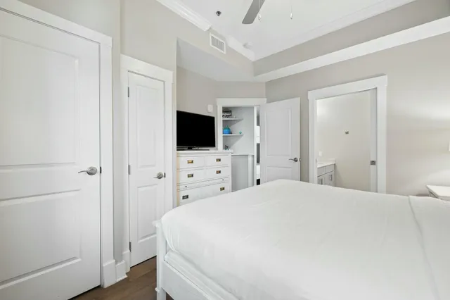 a large white bed in a white room with closet