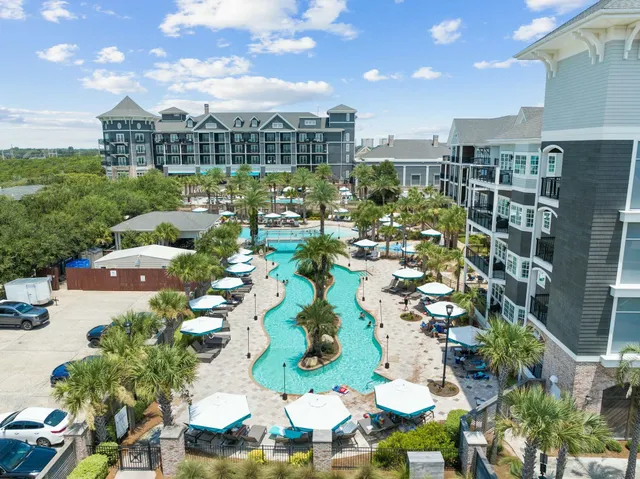 an aerial view of residential houses with outdoor space and swimming pool