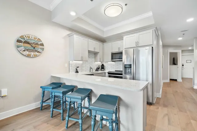 a kitchen with stainless steel appliances a refrigerator and a stove top oven