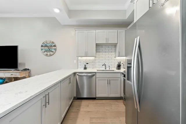 a kitchen with white cabinets and white appliances
