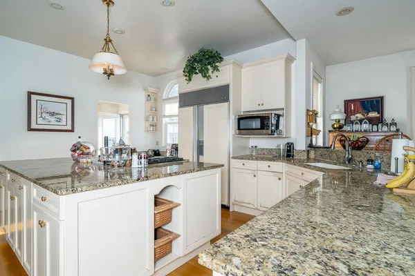 a kitchen with sink refrigerator and microwave