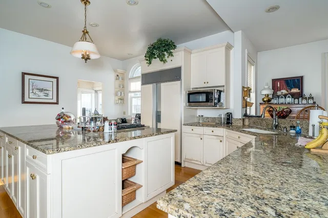 a kitchen with sink refrigerator and microwave