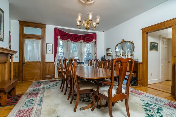 a view of a dining room with furniture and a chandelier