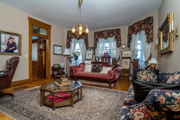 a living room with furniture and a chandelier