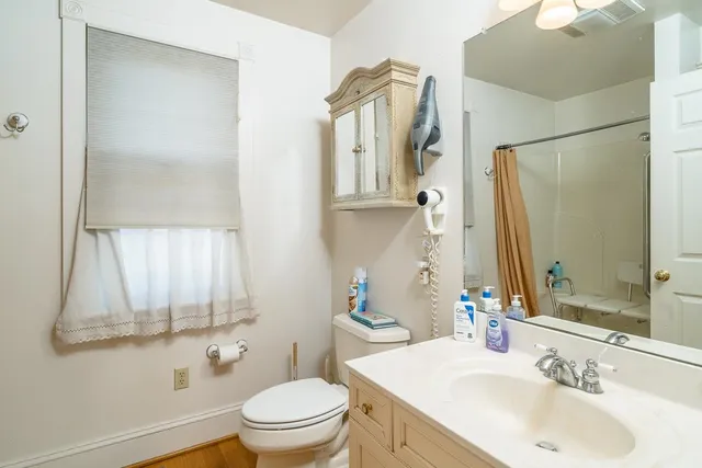 a bathroom with a sink a mirror and a toilet