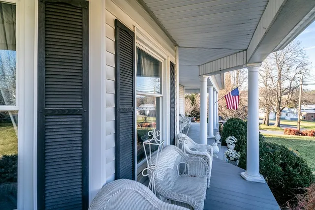 a balcony with furniture and wooden floor