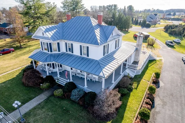 a aerial view of a house with swimming pool and garden