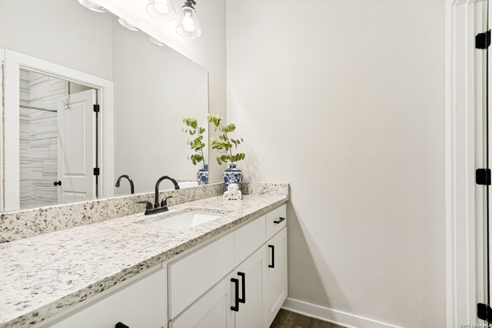 102 Silver Spring Universal City, TX 78148 - Photo 29 of 36 a bathroom with a sink and a mirror