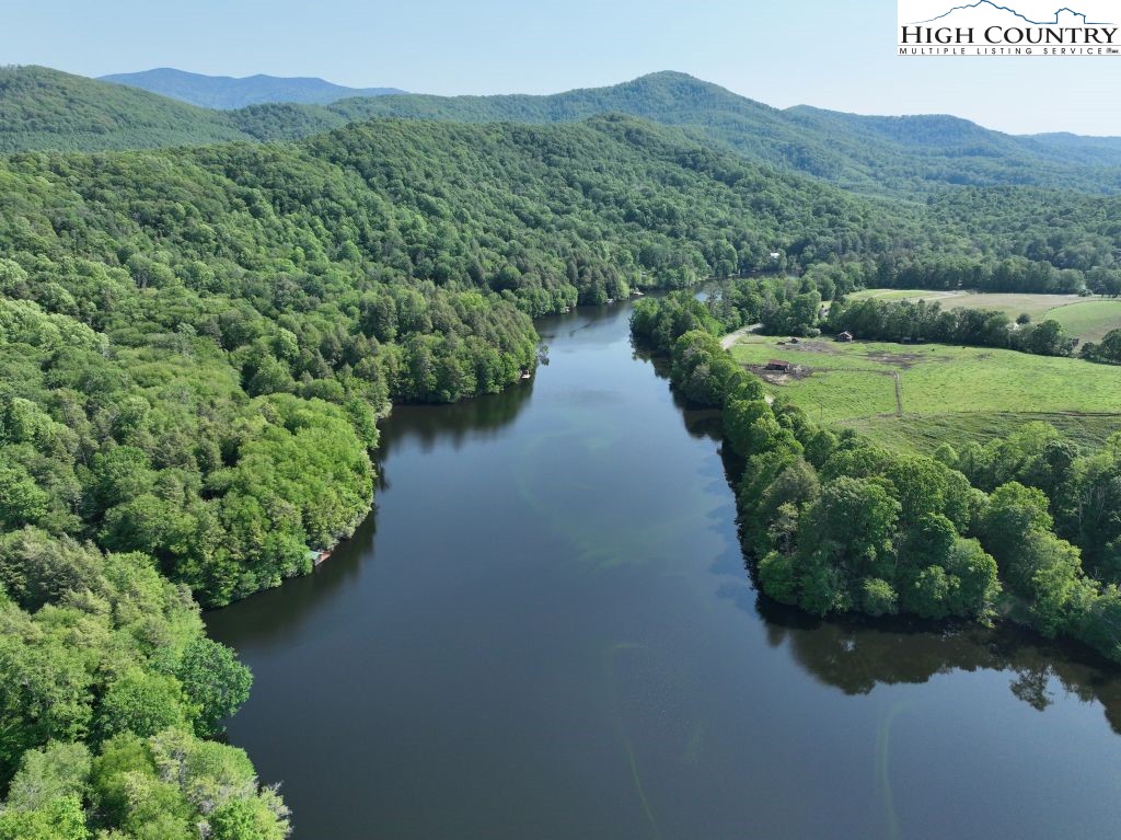 1762 Ripshin Mountain Road Roan Mountain, TN 37687 - Photo 17 of 24 a view of a lake with a mountain in the background