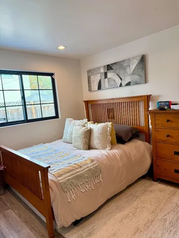 a bedroom with a bed and window