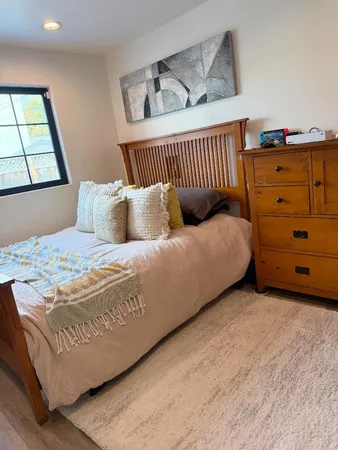 a bedroom with a bed and a window