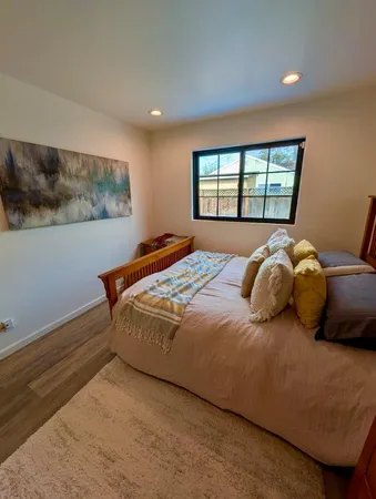 a bedroom with a bed and a window