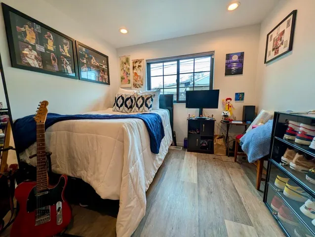 a bed room with a bed and a chair