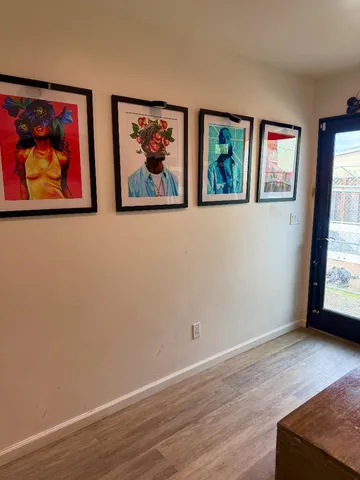 an empty room with wooden floor and window
