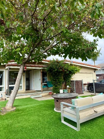 a front view of house with a garden and swing