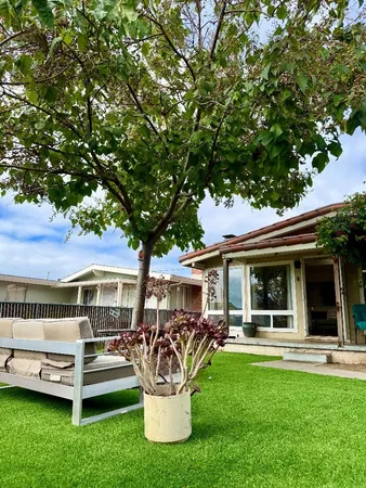 a view of a house with backyard porch and sitting area
