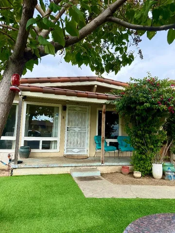 a view of a house with a tree front of it
