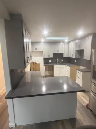 a view of a kitchen with stainless steel appliances