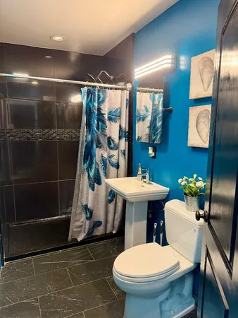 a bathroom with a sink toilet and shower