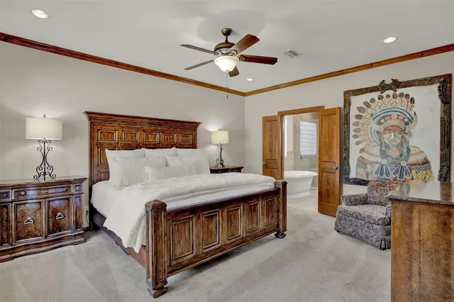 a spacious bedroom with a bed and ceiling fan