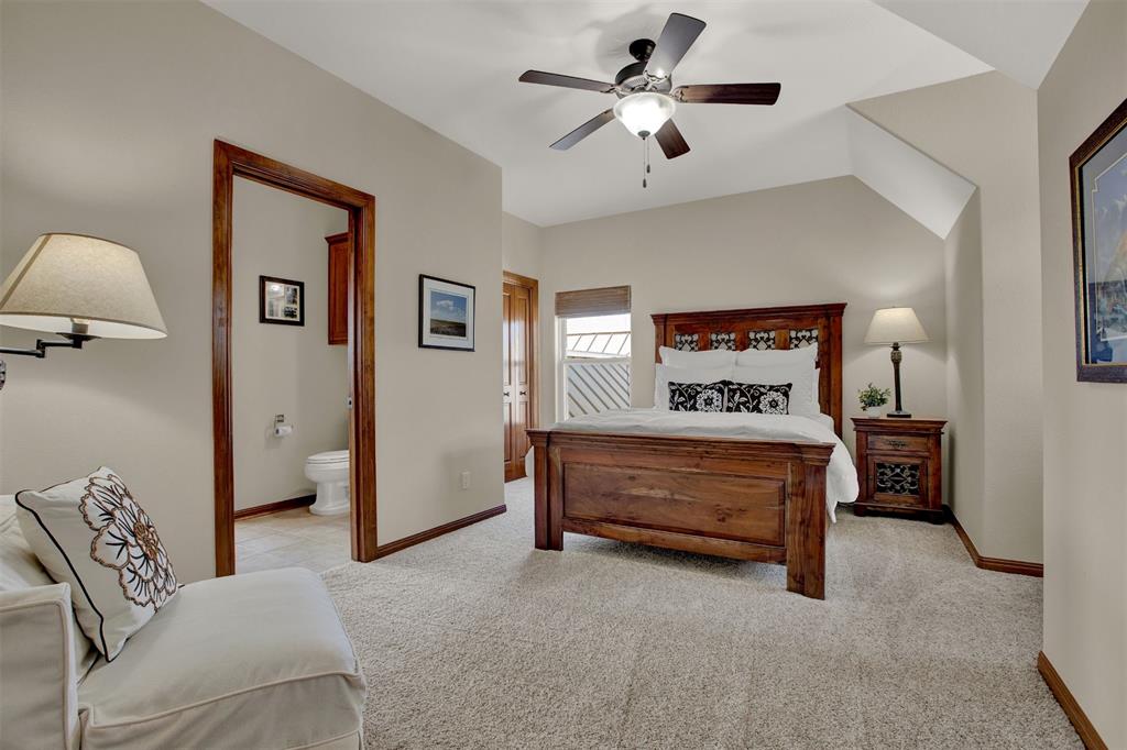 5300 Lookout Ridge Drive Marble Falls, TX 78654 - Photo 22 of 40 a bedroom with a bed and a chandelier