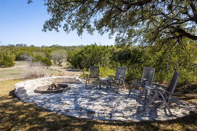 a view of a backyard with sitting area