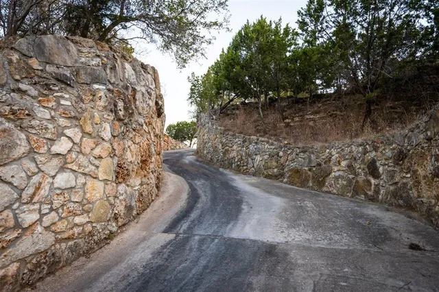 a view of a wooden fence with trees