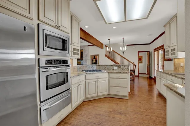 a kitchen with stainless steel appliances granite countertop a stove and a sink