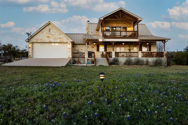 a view of a big house with a big yard and large trees
