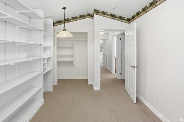 2190 750 West Perry, UT 84302 - Photo 24 of 42 Room featuring extensive built-in shelving, a recessed closet with additional shelving, and a hanging pendant light fixture