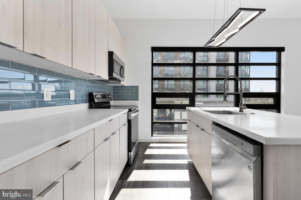 506 H Street Northeast, Unit 401 Washington, DC 20002 - Photo 1 of 19 a kitchen with stainless steel appliances a sink stove and cabinets