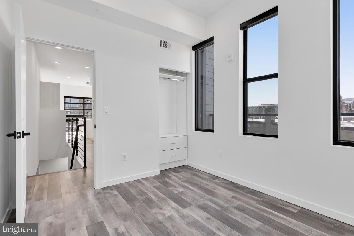 506 H Street Northeast, Unit 401 Washington, DC 20002 - Photo 12 of 19 wooden floor in an empty room