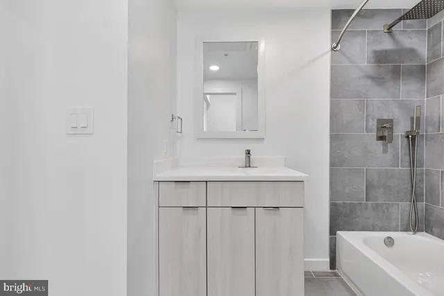 a bathroom with a sink a bathtub and a shower
