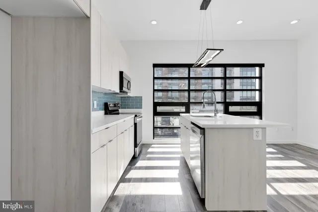 a kitchen with a sink and cabinets