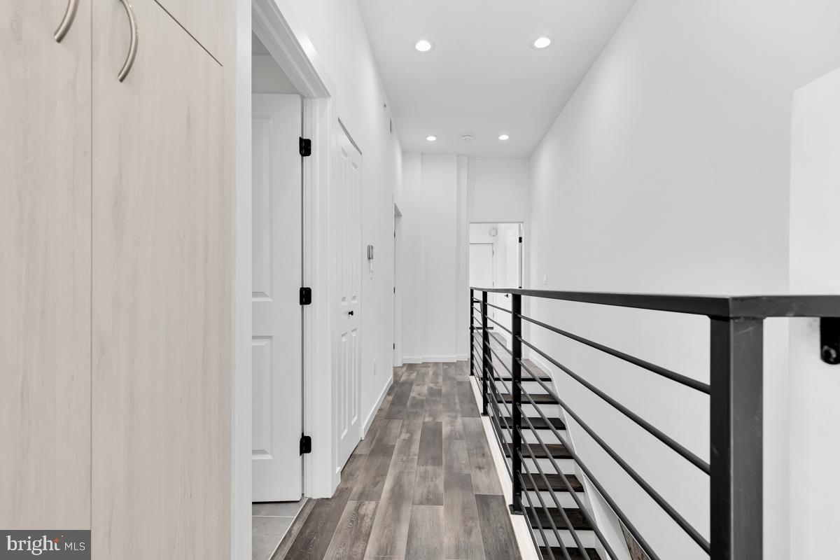 506 H Street Northeast, Unit 401 Washington, DC 20002 - Photo 10 of 19 a view of a hallway with wooden floor and stairs