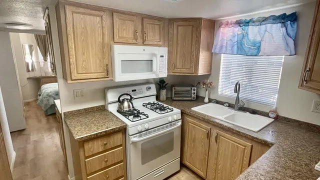 a kitchen with a sink stove and cabinets