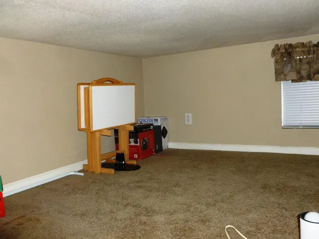 a view of a room with gym equipment and a window