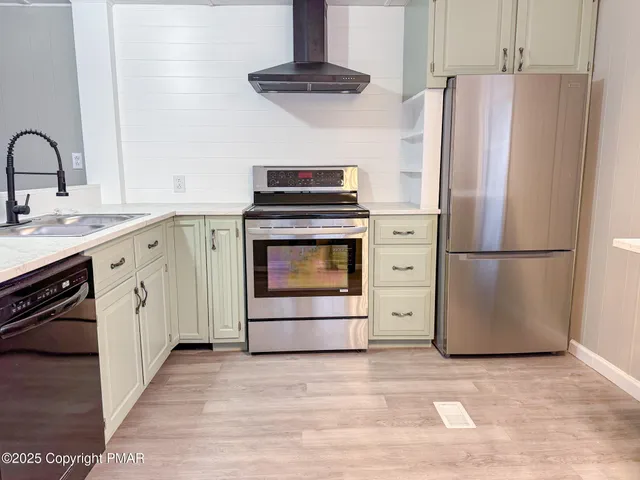 a kitchen with granite countertop white cabinets and a stove