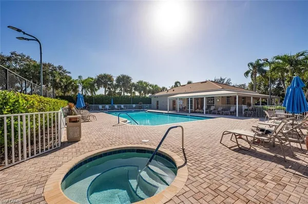 a view of a swimming pool with a patio and a yard