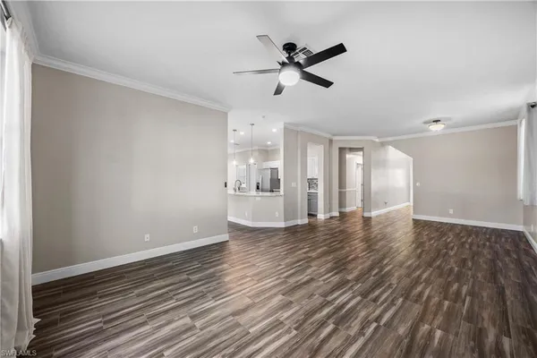 a view of empty room with wooden floor