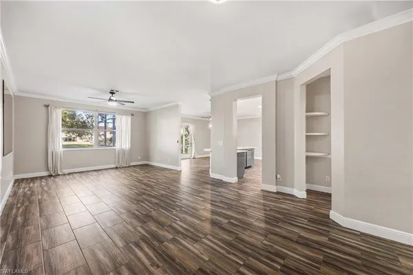 a large kitchen with kitchen island white cabinets and wooden floor