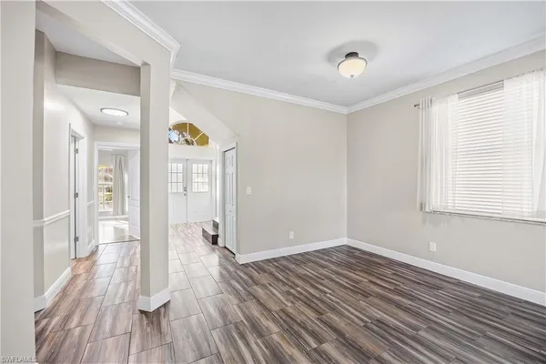 a large kitchen with a lot of counter space and wooden floor