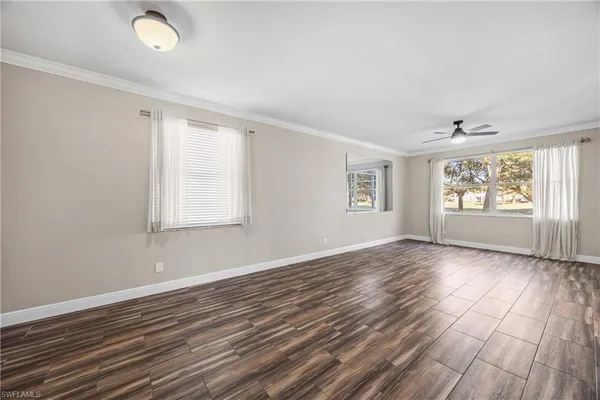 a view of room with window and wooden floor