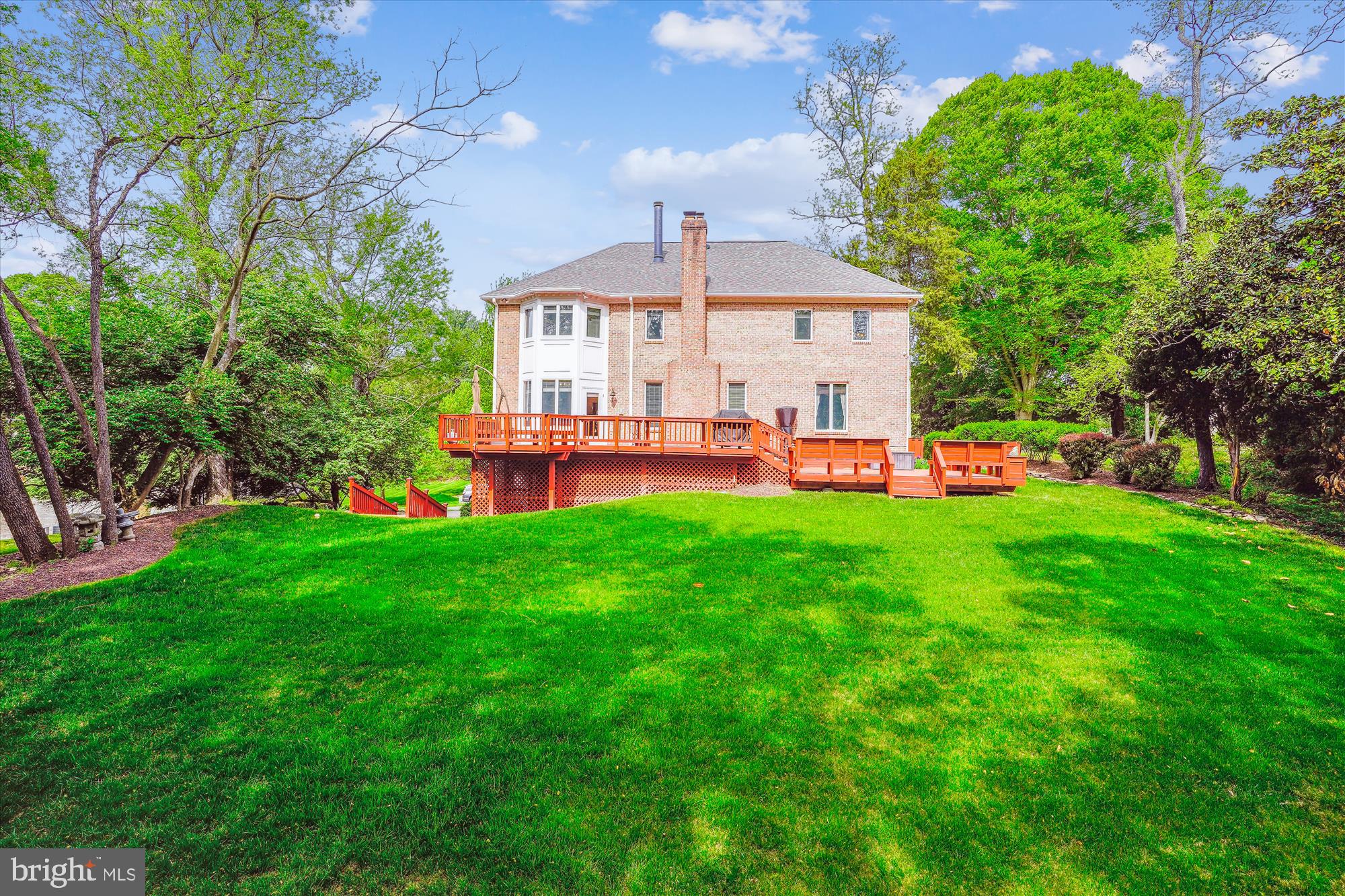 1071 Spring Hill Road McLean, VA 22102 - Photo 2 of 65 a front view of a house with a yard table and chairs