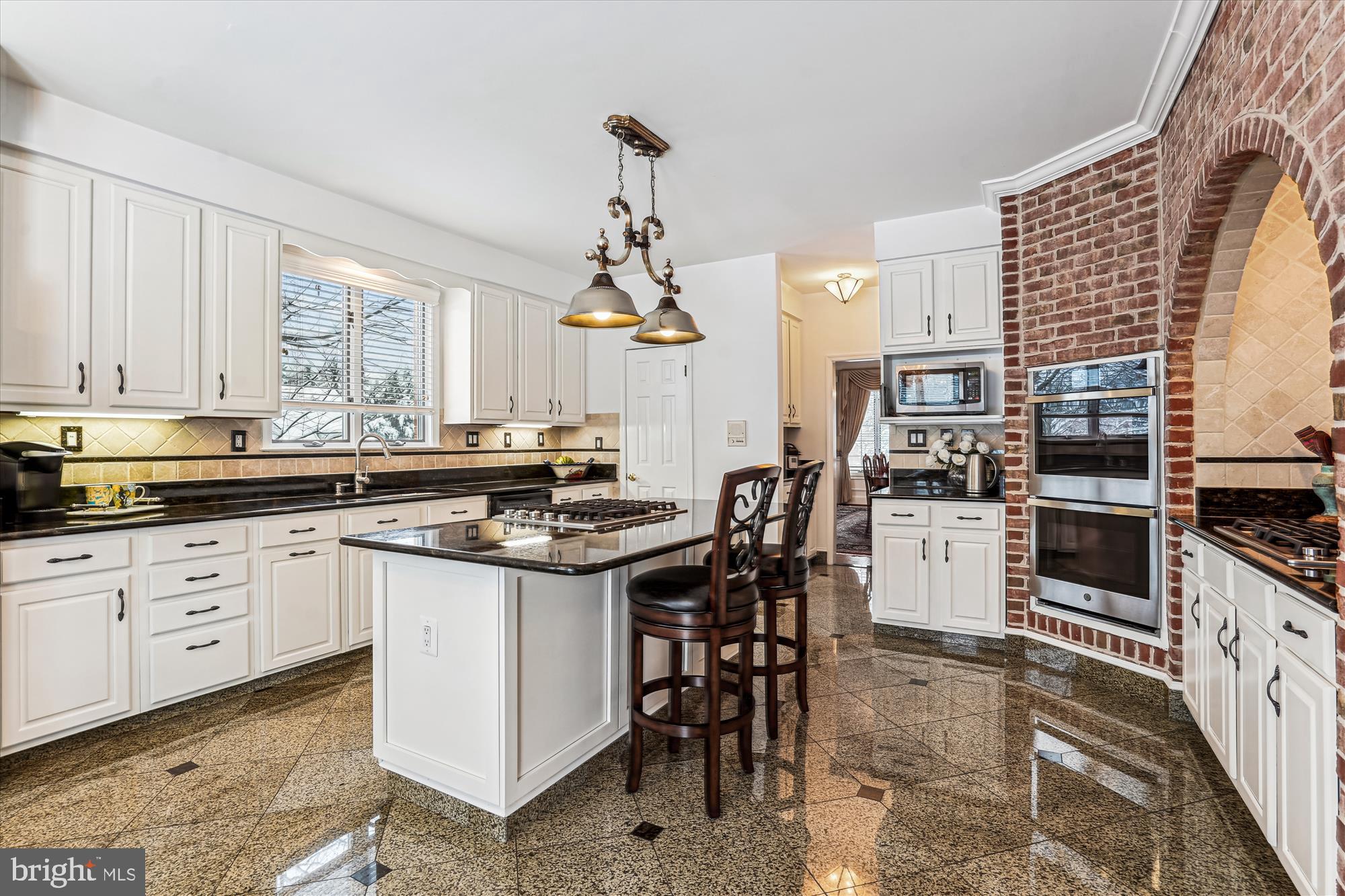 1071 Spring Hill Road McLean, VA 22102 - Photo 8 of 65 a kitchen with stainless steel appliances kitchen island granite countertop a sink and cabinets