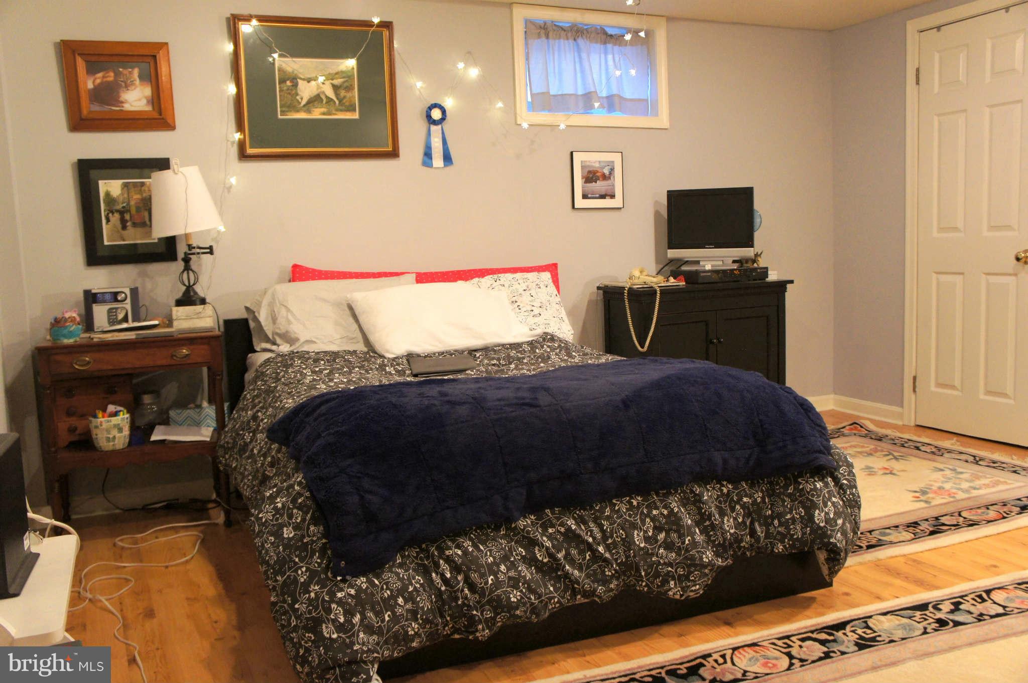 151 Stanmore Road Baltimore, MD 21212 - Photo 17 of 29 a bedroom with a bed and wooden floor