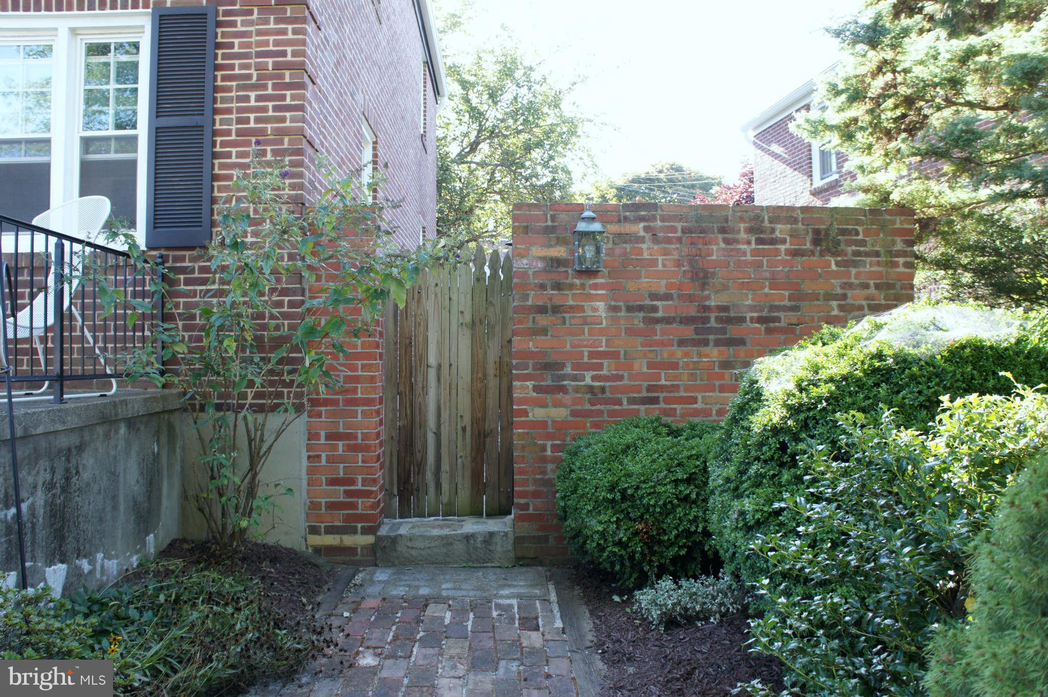 151 Stanmore Road Baltimore, MD 21212 - Photo 26 of 29 a brick building with a yard and plants
